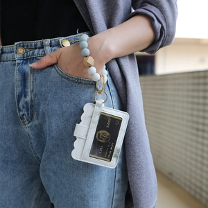 Detailed shot of white PU leather card holder with colorful silicone beaded wristlet keychain