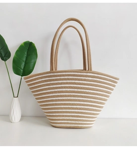Detail of hand-woven striped cotton tote bag with macro texture and resort style aesthetic