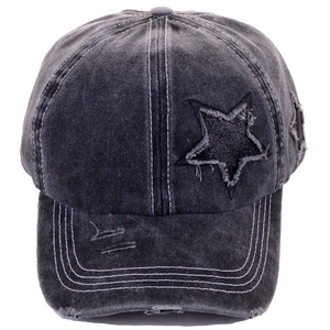 Detailed view of distressed denim baseball cap with star patch and frayed edges