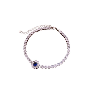Sparkling silver flower bracelet with blue gemstone centerpiece and white zircon stones