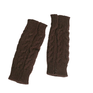 Detailed knit texture of dark brown cable-knit arm warmers with classic twisted pattern