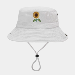 Detail of white cotton bucket hat featuring sunflower embroidery and adjustable wind cord