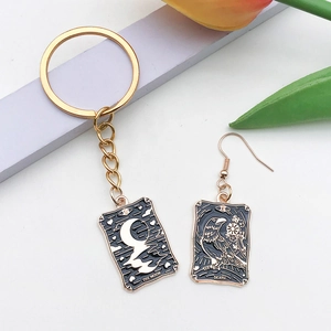 Détail macro de pendentifs tarot avec la lune et la mort en finition émail noir