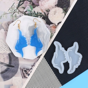 Face silhouette earrings next to their translucent silicone mold for resin crafting