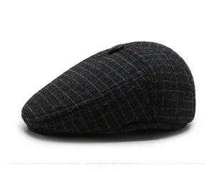 Side view of men's dark grey checkered wool flat cap featuring a classic top button