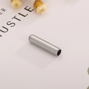 Vista macro di un connettore cilindrico in acciaio inossidabile argento per gioielli DIY
