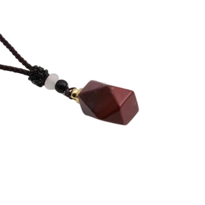 Detailed view of red tiger eye gemstone perfume bottle pendant with woven cord necklace