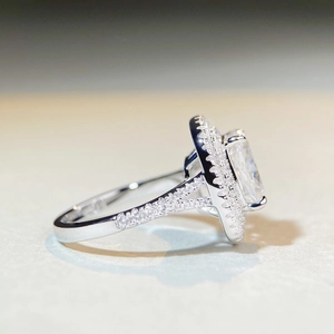 Macro side view of S925 silver moissanite ring with square cut stone and halo setting