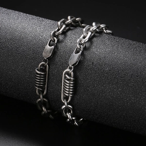 Industrial style stainless steel link bracelet with spring charms in antique silver finish