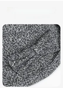Detailed view of the tweed texture and 3D bow decoration on the winter basin hat