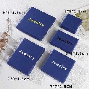 Blue jewelry gift boxes in five sizes with gold logo on white marble background