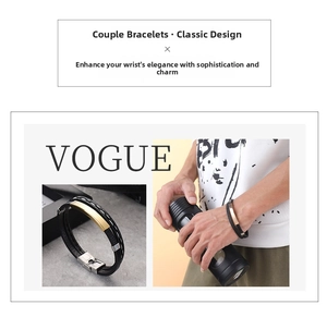 Detail of layered black braided leather bracelet with a polished gold metal clasp