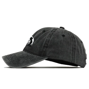Detail shot of white skeleton embroidery on washed charcoal grey cotton baseball cap