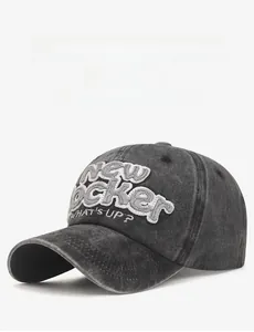 Close-up of the vintage washed dark grey denim baseball cap with 3D embroidery detail