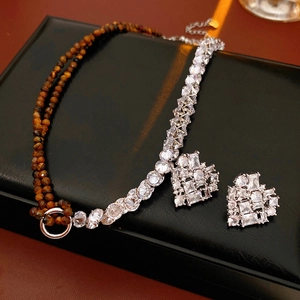Macro shot of heart-shaped zircon jewelry set on luxury black leather gift box display