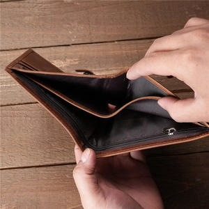 Detail view of brown vintage leather wallet showing internal card slots and zipper pocket