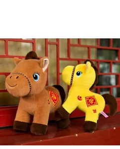 Detailed view of two festive Chinese zodiac horse plush toys with traditional patterns