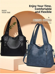 Detail view of large tote bags in black and blue leather with U-shaped metal accents