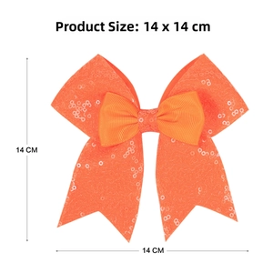 Detail view of large orange sequin bow hair clip with 14x14 cm size specifications