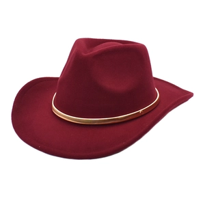 Close-up of wine red western cowboy felt hat featuring a fine gold metal decorative band