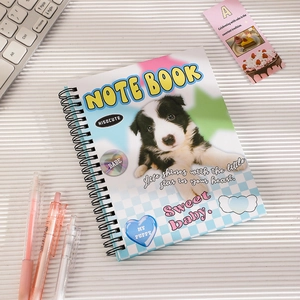 Flat lay of dog theme spiral notebook with mechanical keyboard and a pink pen on desk