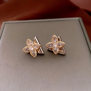 Minimalist silver needle zircon flower stud earrings on luxury silk background