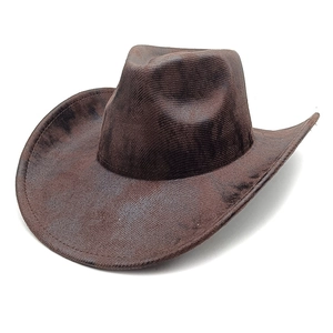 Macro shot of dark brown western cowboy hat with vintage distressed texture and wide brim