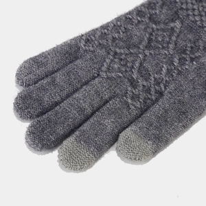 Close-up of dark grey knitted gloves with touchscreen-compatible fingertips and diamond pattern