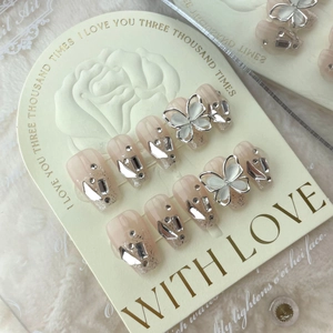 Handmade gradient nude pink press-on nails with silver glitter and metal butterfly charms