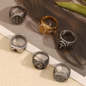 Macro detail of vintage gold and silver rings with cross and Caesar carvings