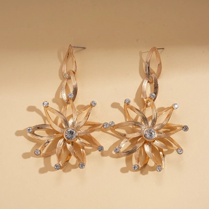 Detail of golden sunflower chain earrings with sparkling rhinestones in a luxury finish