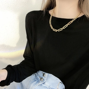 Golden titanium steel Cuban chain choker necklace shown on a female model with sleek look