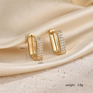 Detail view of gold huggie earrings with double row pave zircon and size dimensions