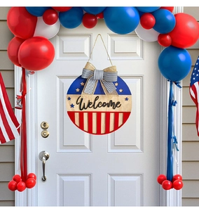 Detail of Fourth of July wooden welcome sign with American flag stars, stripes and bow