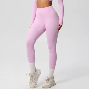 Detail of light pink high-waist yoga pants with brushed texture and butt-lifting seam
