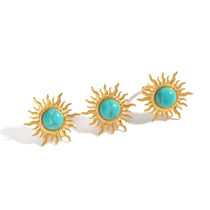 Vintage golden sun-shaped rings with inlaid turquoise stones on a white background