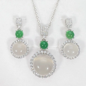 Elegant silver jewelry set with white chalcedony pendants and green gemstone accents