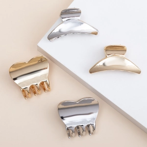 Set of four minimalist gold and silver metal hair claws in heart and crescent shapes