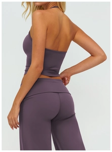 Detailed back view of deep purple one-shoulder yoga top and high-waisted leggings set