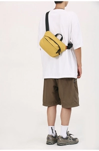 Rear view of bright yellow crossbody bag showing large capacity and adjustable black strap