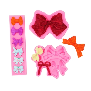 Macro view of pink silicone bow molds for DIY cake decorating and handmade soap