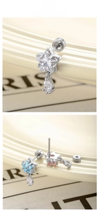 Detailed view of star-shaped zircon ear studs with teardrop pendants in multiple colors