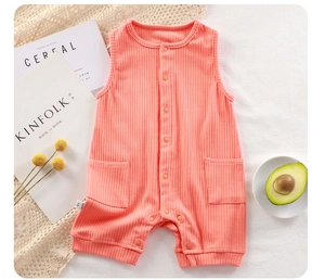 Detailed view of pink cotton ribbed baby romper with front buttons and side pockets