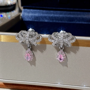 Pink teardrop gemstone bow earrings with silver base and pavé rhinestones in a gift box