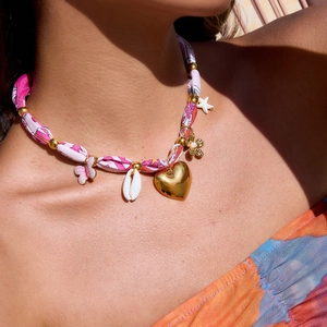 Detail of 18K gold stainless steel necklace with pink butterflies and ocean charms