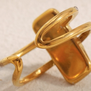 Detailed macro view of 18K gold plated double layer ring with shell and diamond accents