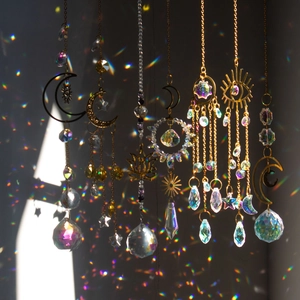 K9 crystal suncatcher with golden lotus moon and rainbow light reflection on dark background