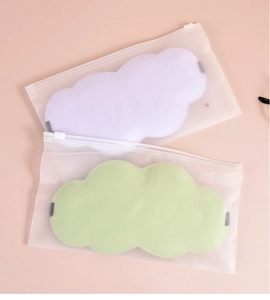 Detailed view of cloud-shaped sleep masks in pastel purple and green with soft fabric texture