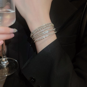 Detailed view of multilayer silver diamond bracelet with sparkling crystals on wrist