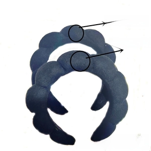 Close-up of black braided padded sponge headband showing thick fabric and soft texture